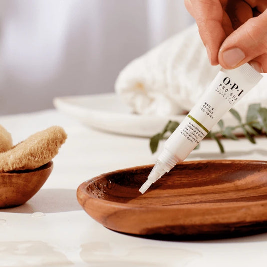 O.P.I._Pro_Spa_Nail_Cuticle_Oil-to-Go_7_5ml_witte_tube_houten_bord druppels houten schaaltje 