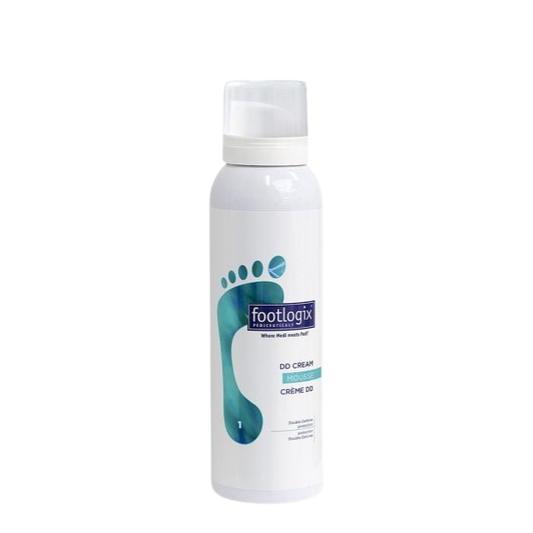 Footlogix DD Cream Mousse 125 ml, een verzorgende schuimcrème voor droge voeten met een ruwe of verkleurde huid. Camoufleert oneffenheden en hydrateert tegelijk. Op de foto de witte fles met blauwe voetafbeelding. Puur Diana Shop Nuenen