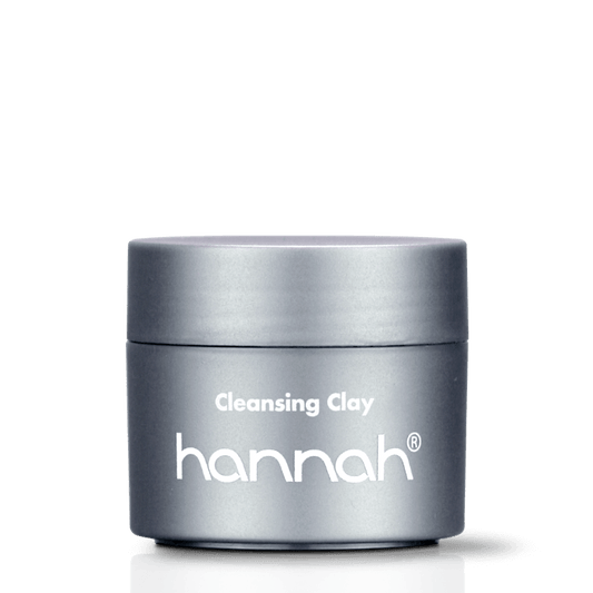 hannah Cleansing Clay 65 ml, een diepreinigend kleimasker met kaolin en bentonite voor een huid die snel glimt, verstopte poriën heeft en regelmatig onzuiverheden ontwikkelt. De klei neemt overtollig talg op en maakt het huidbeeld zichtbaar rustiger en verfijnder. Op de foto de verpakking van 65 ml tegen een neutrale achtergrond. Puur Diana Shop Nuenen