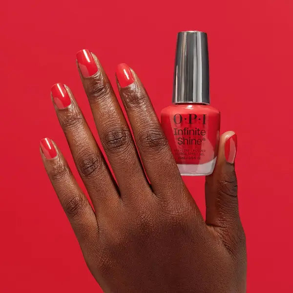 O.P.I Infinite Shine Cajun Shrimp, hand met het flesje van de rode nagellak. Puur Diana Shop Nuenen